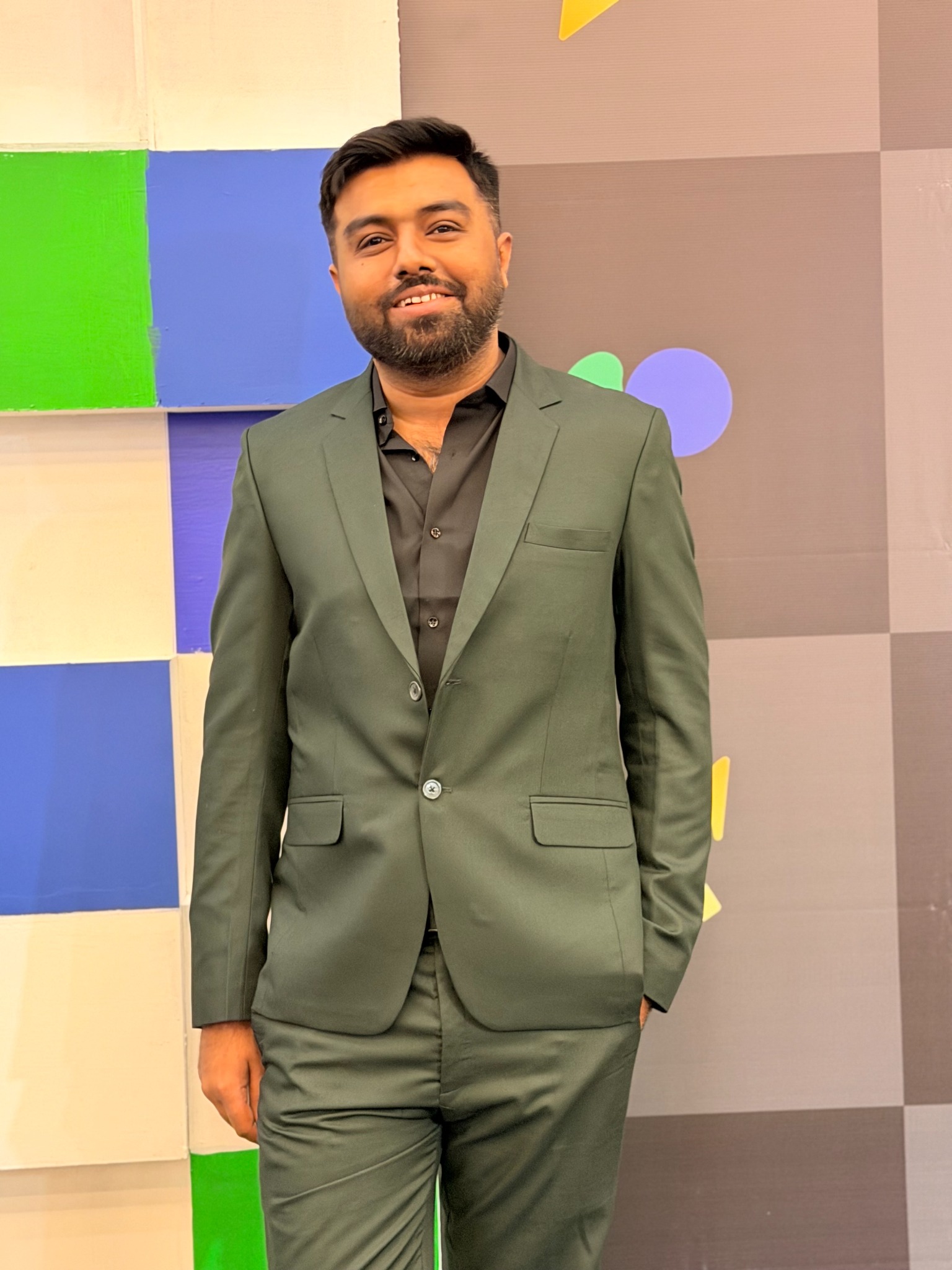 Ghulam Muhammad wearing a green suit